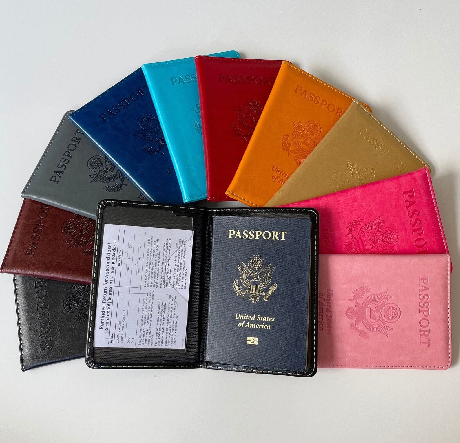 The black card holder surrounded by other card holders in all 10 colors