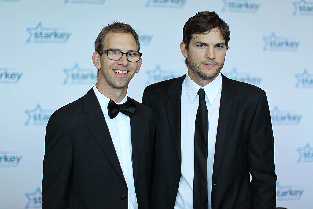 Michael Kutcher and brother Ashton Kutcher walk the red carpet