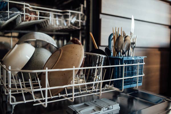 A dishwasher filled with dirty dishes.