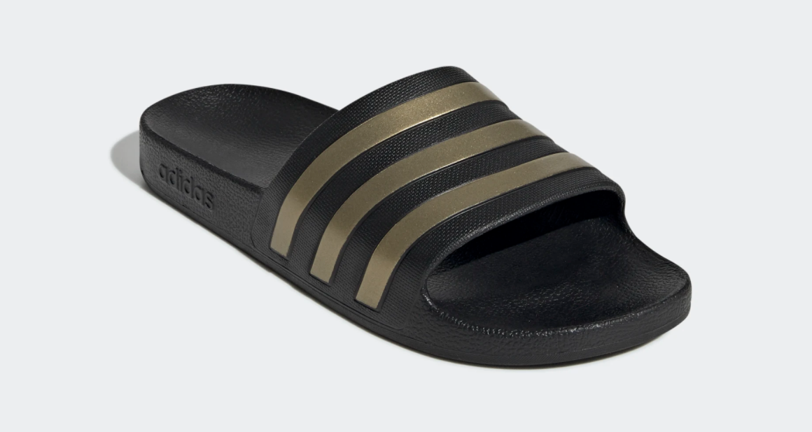 black slides with three gold stripes on the front