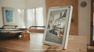 gif of older person video chatting with a younger family and them waving