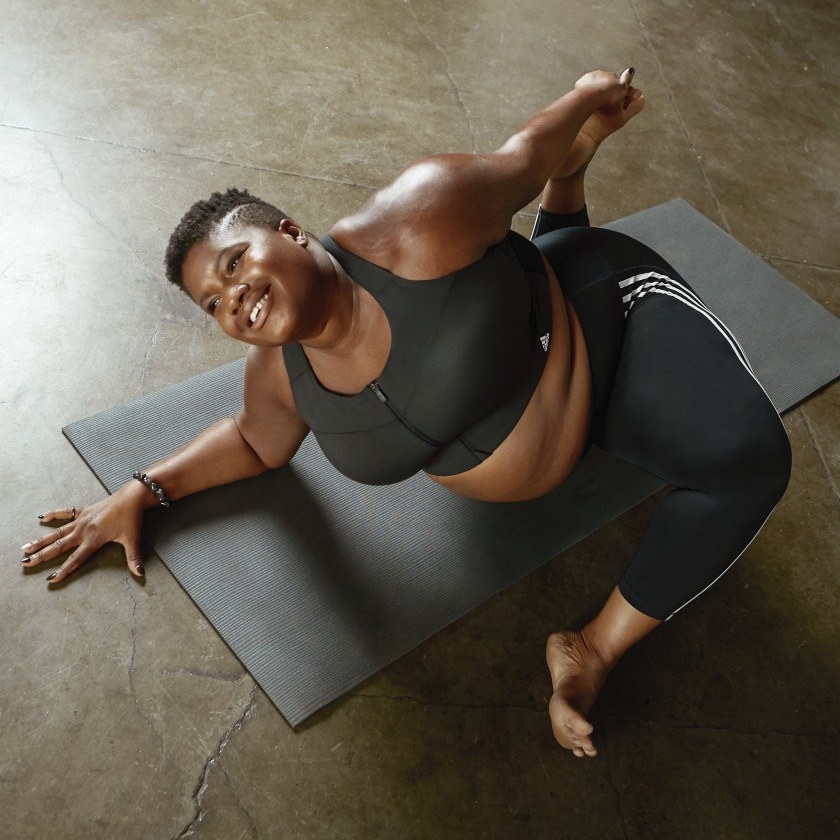 Model in a yoga pose wearing the black sports bra