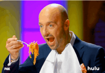 a gif of a person happily shovelling spaghetti into their open mouth
