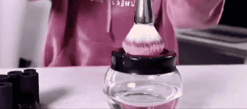 gif of person cleaning a brush in the bowl and the water turning dirty