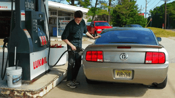 A man filling gas in his car.