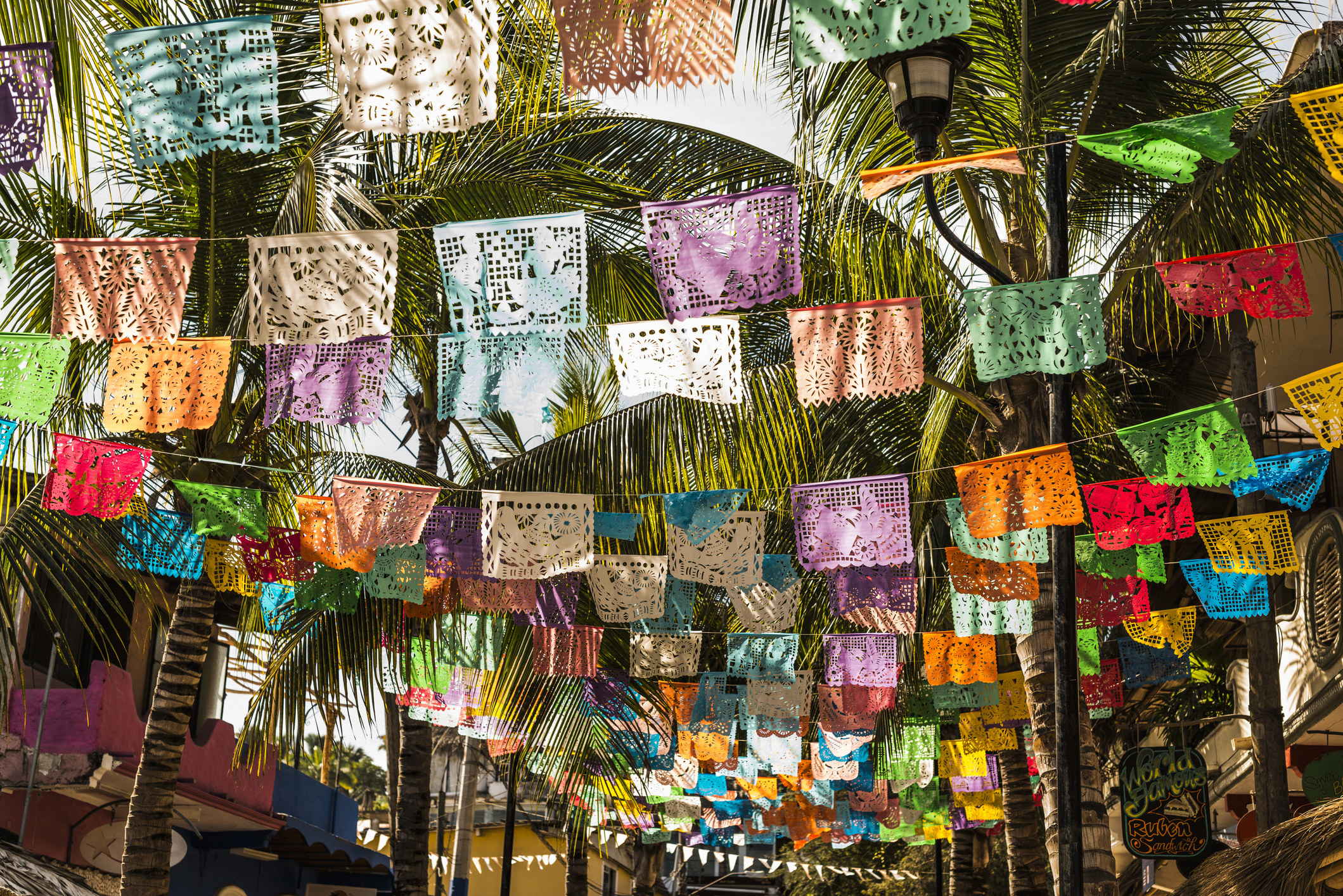 Colorful flags under palm trees in Sayuluta.