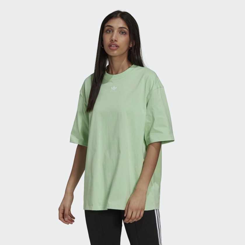 model in light green tee-shirt with white adidas logo on the front