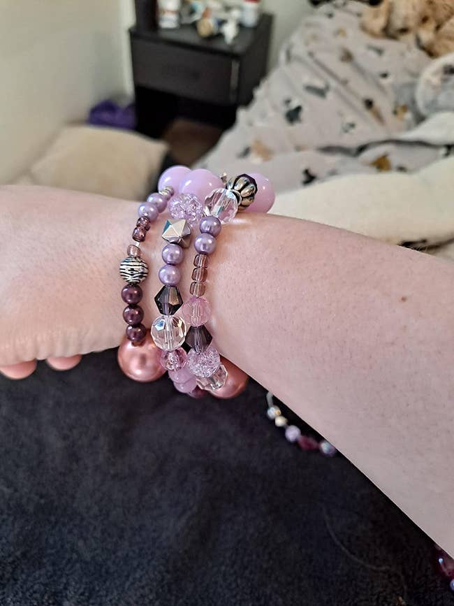 reviewer's hand with three DIY bracelets on their wrist