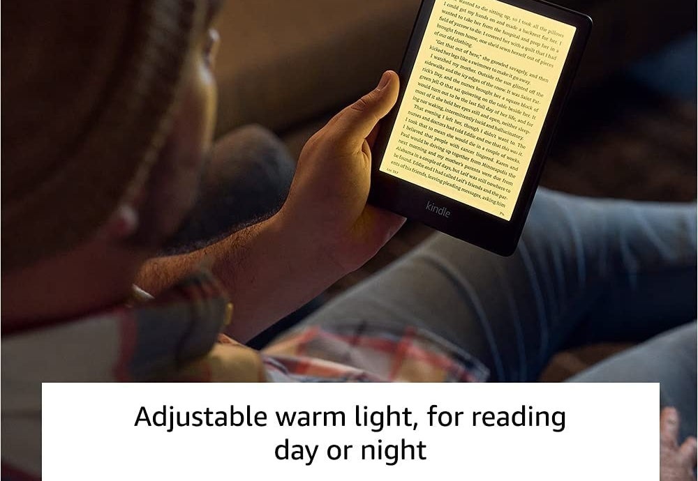 A person reading the Kindle using the warm light setting