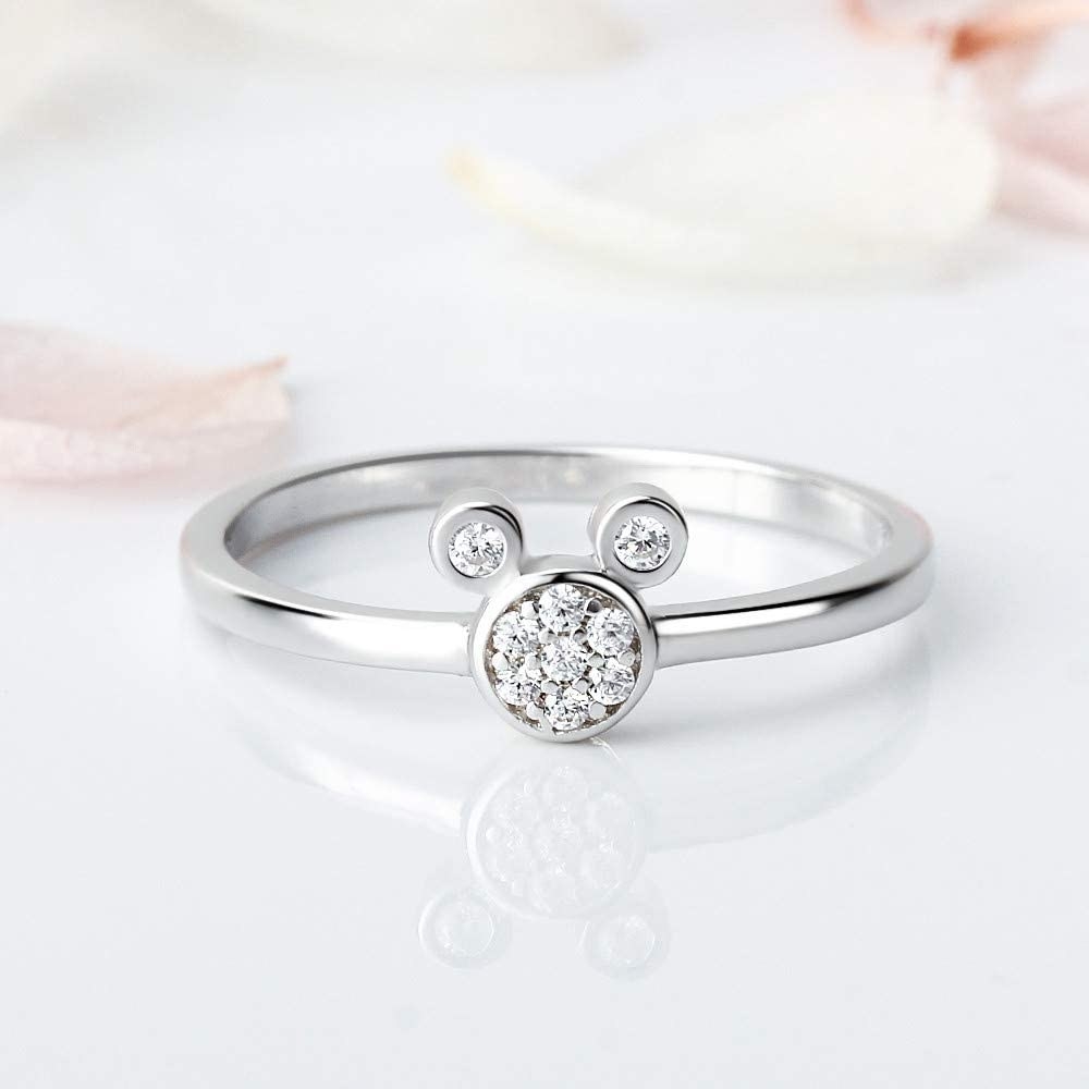 a silver ring with a cubic zirconia mickey head in the middle