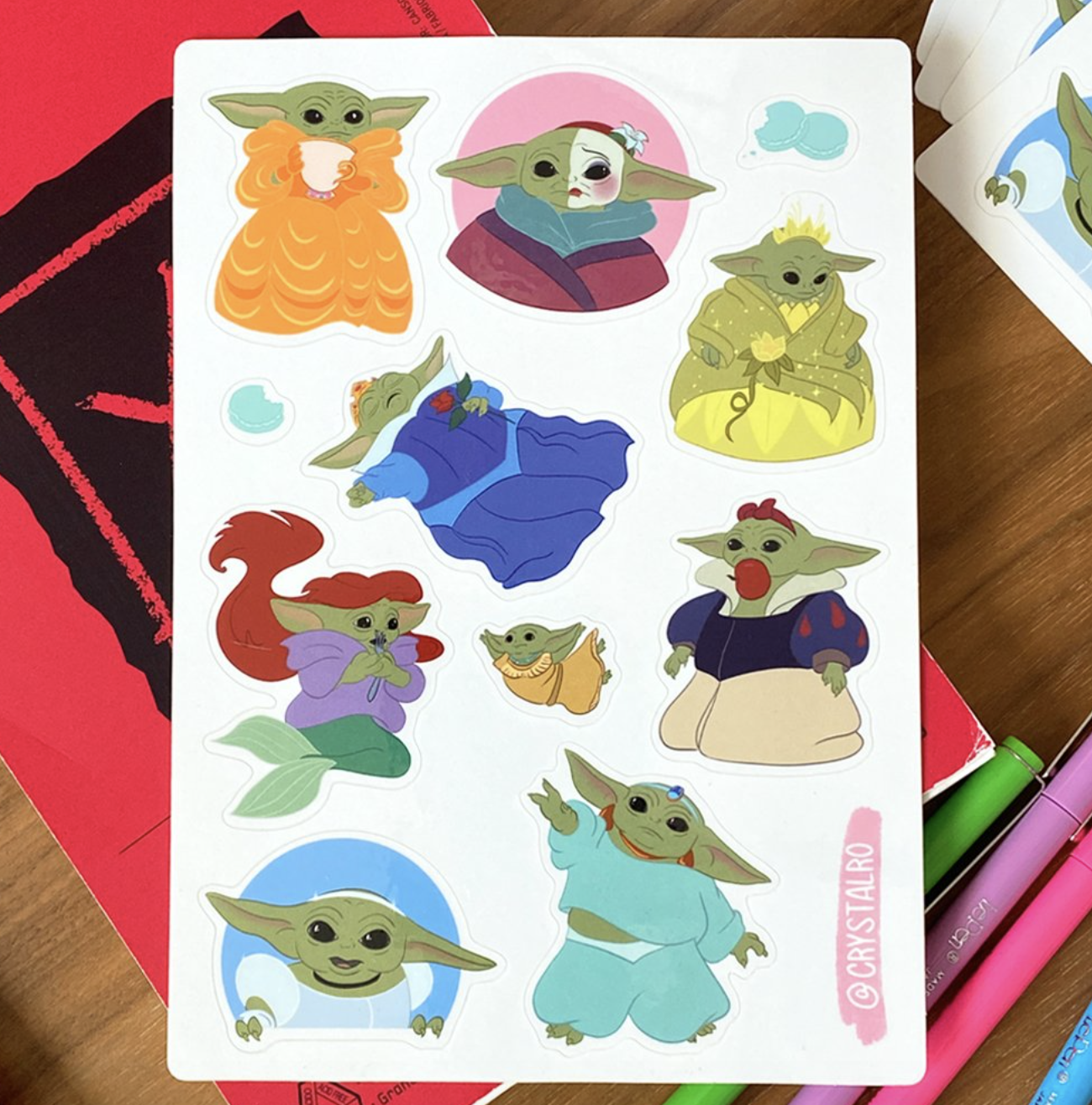 a sticker sheet of baby yoda as different disney princesses