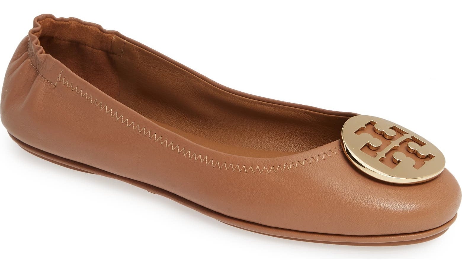 The tan ballet flat with Tory Burch&#x27;s signature medallion in gold