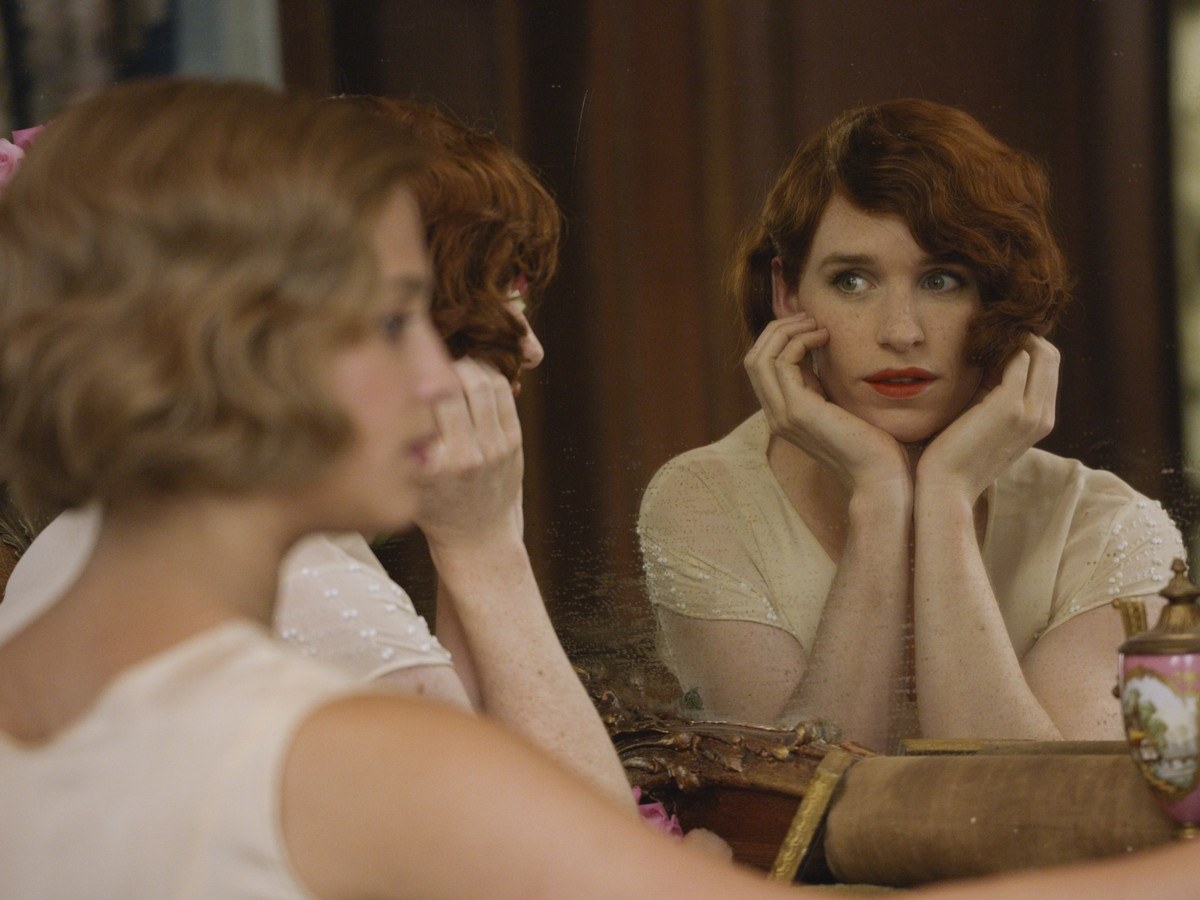 Still from The Danish Girl of Eddie Redmayne as Lili Elbe, looking into a mirror
