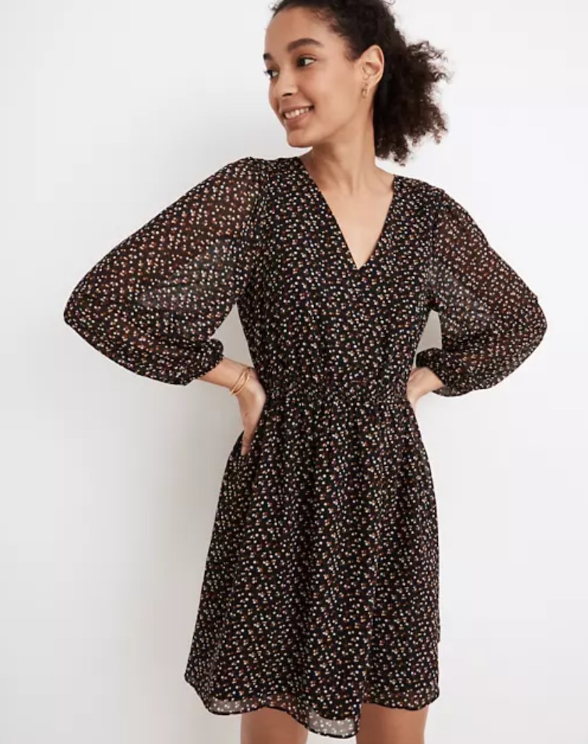 model wearing the brown dress with red and white patterned dots on it
