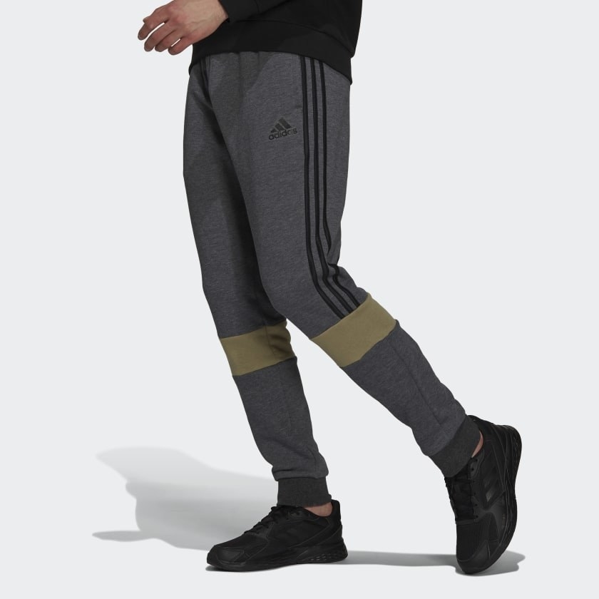 gray colorblock fleece sweatpants with gold detailing on knees and black stripes on side