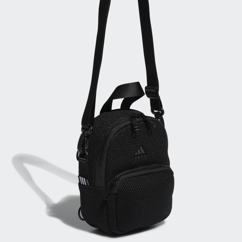 mesh black mini backpack with front zip pockets and black crossbody strap