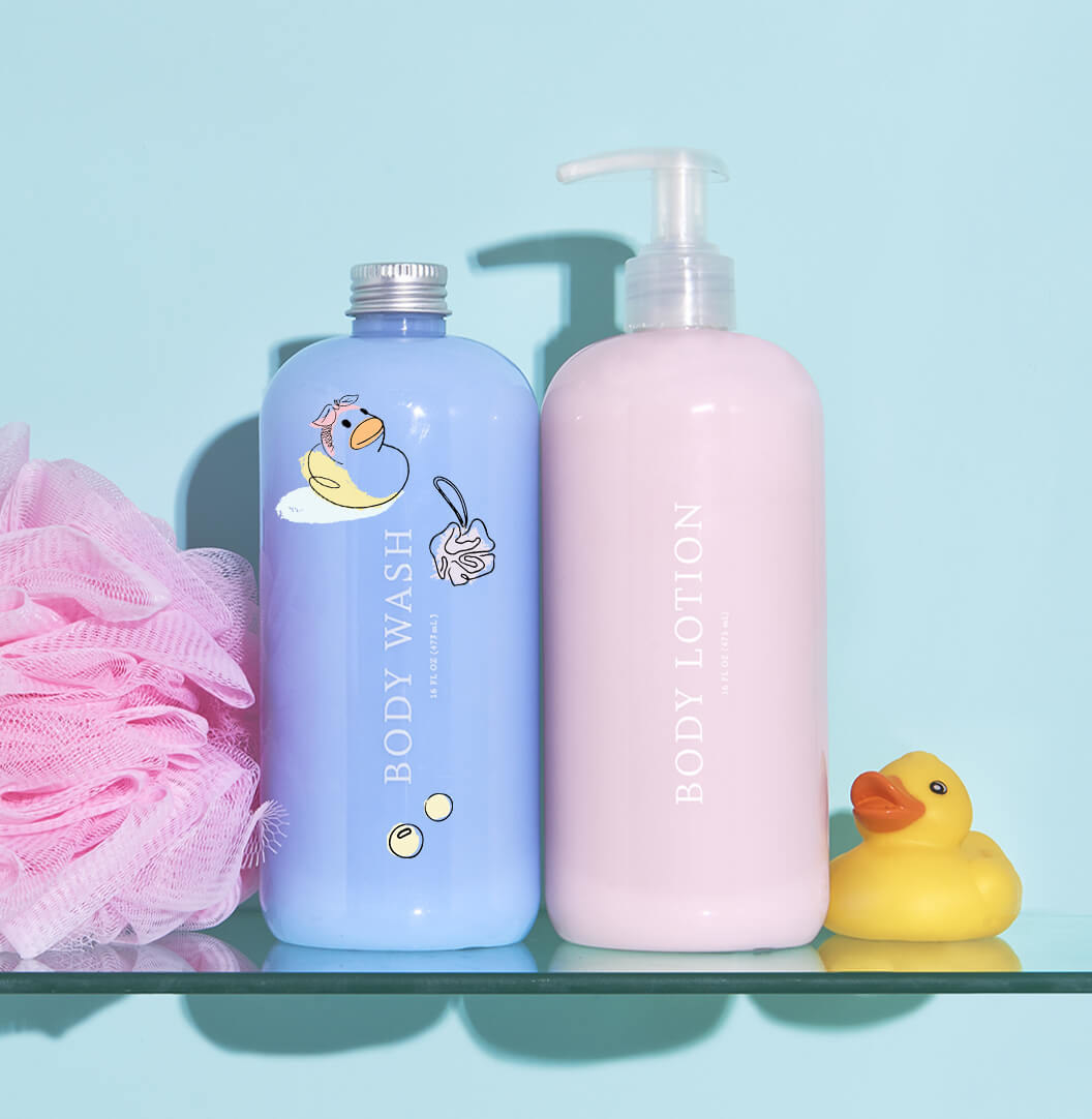 bottle of light blue body wash next to bottle of light pink lotion