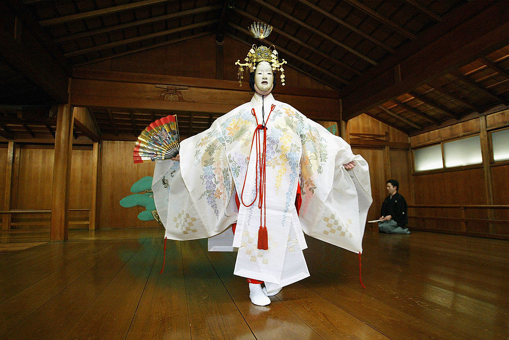 A Noh performing wearing a mask