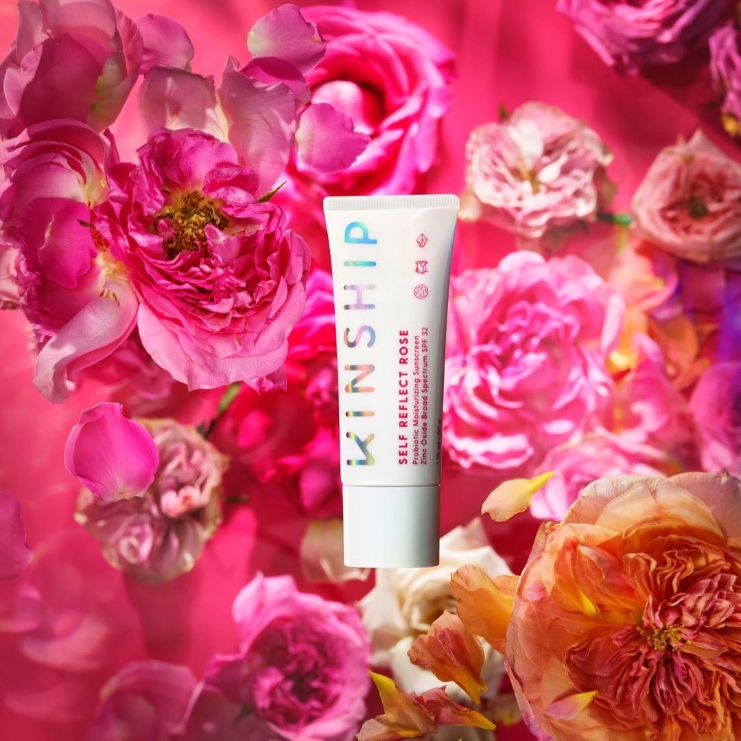 rose-scented sunscreen against a backdrop of roses