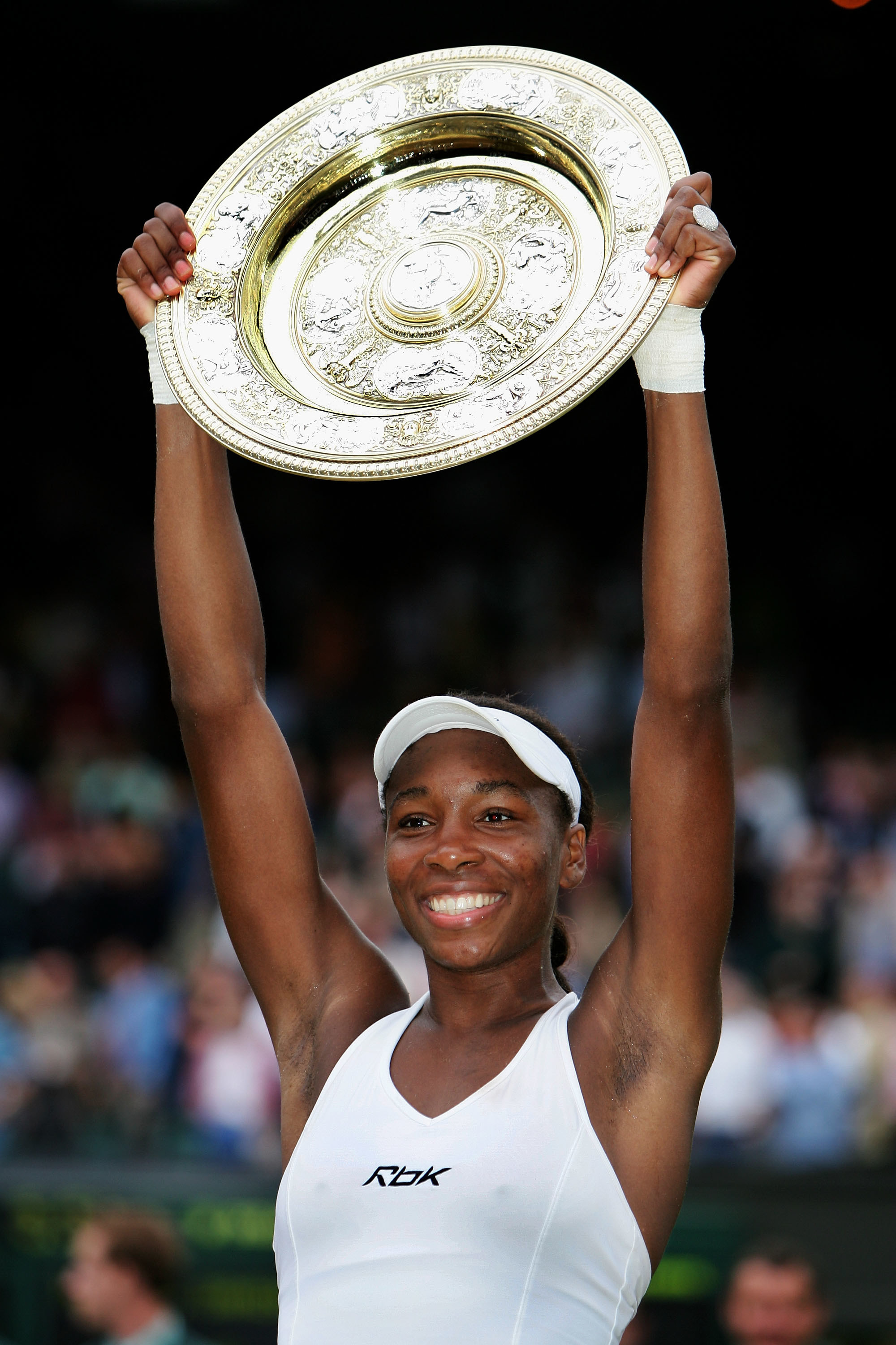 Venus Williams of USA holds the trophy after winning in three sets against Lindsay Davenport during the Ladies Final on the twelfth day of the Wimbledon Lawn Tennis Championship in 2005