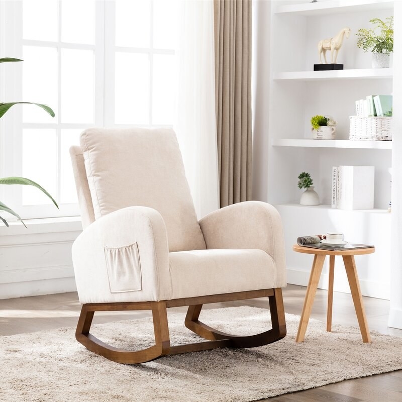 Light beige cushioned rocking chair glider, with wooden rocking base