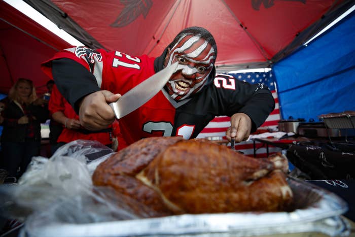 A falcons fan carves a turkey