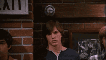 Ashton Kutcher beneath a lightbulb.