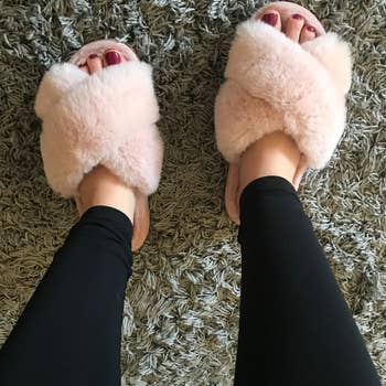 reviewer wearing fuzzy pink slides