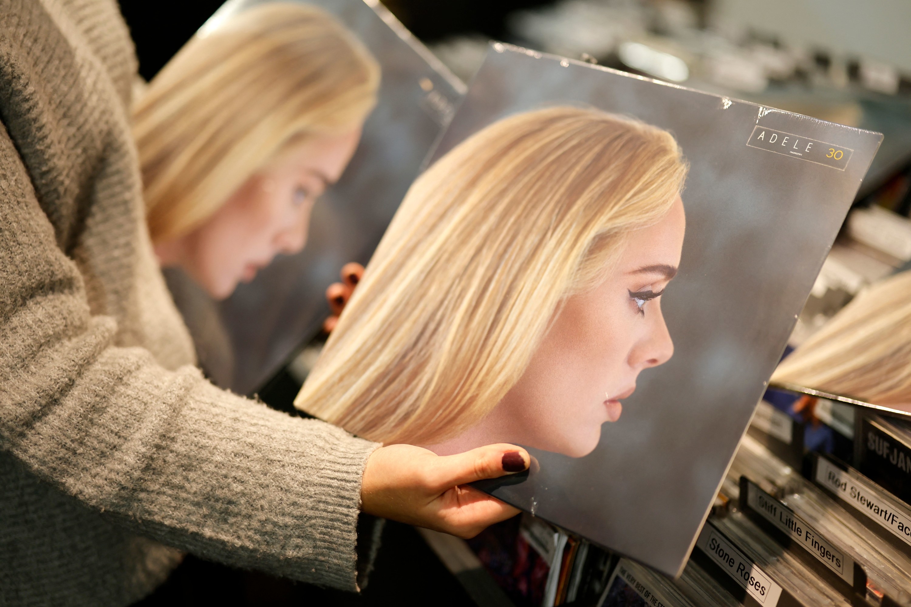 Photo of someone holding up a vinyl edition of Adele&#x27;s album 30