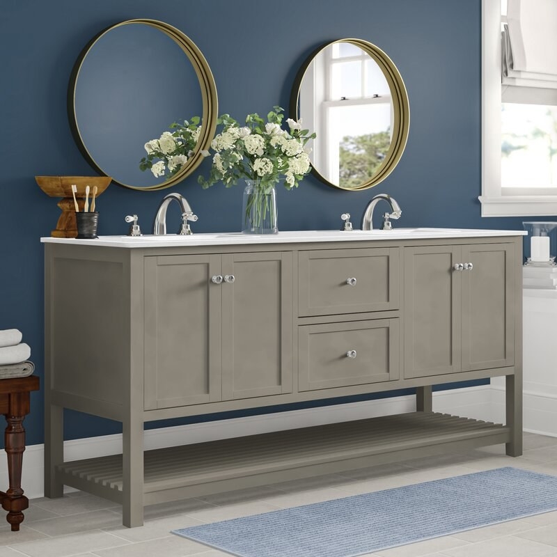 Gray double bathroom vanity with two round mirrors above it