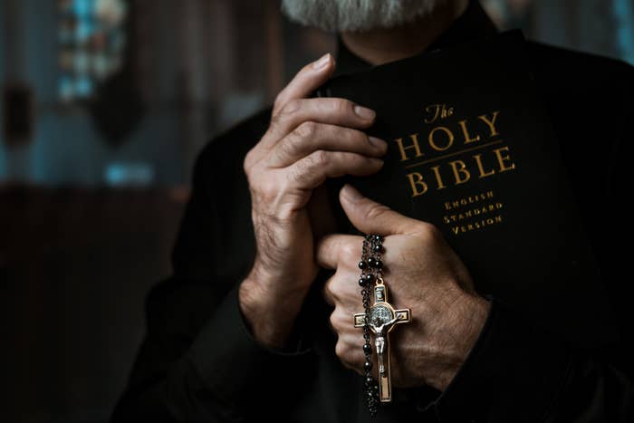 A priest holding a bible