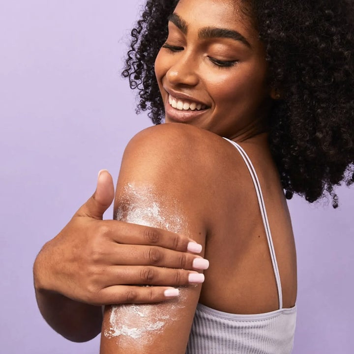 a person using the body scrub on their arm