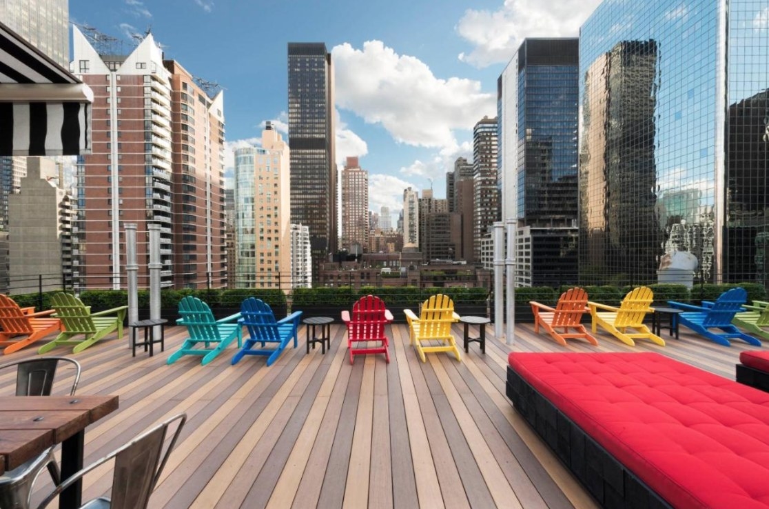 a photo of Pod 51&#x27;s rooftop garden with lounge chairs looking out over the manhattan skyline