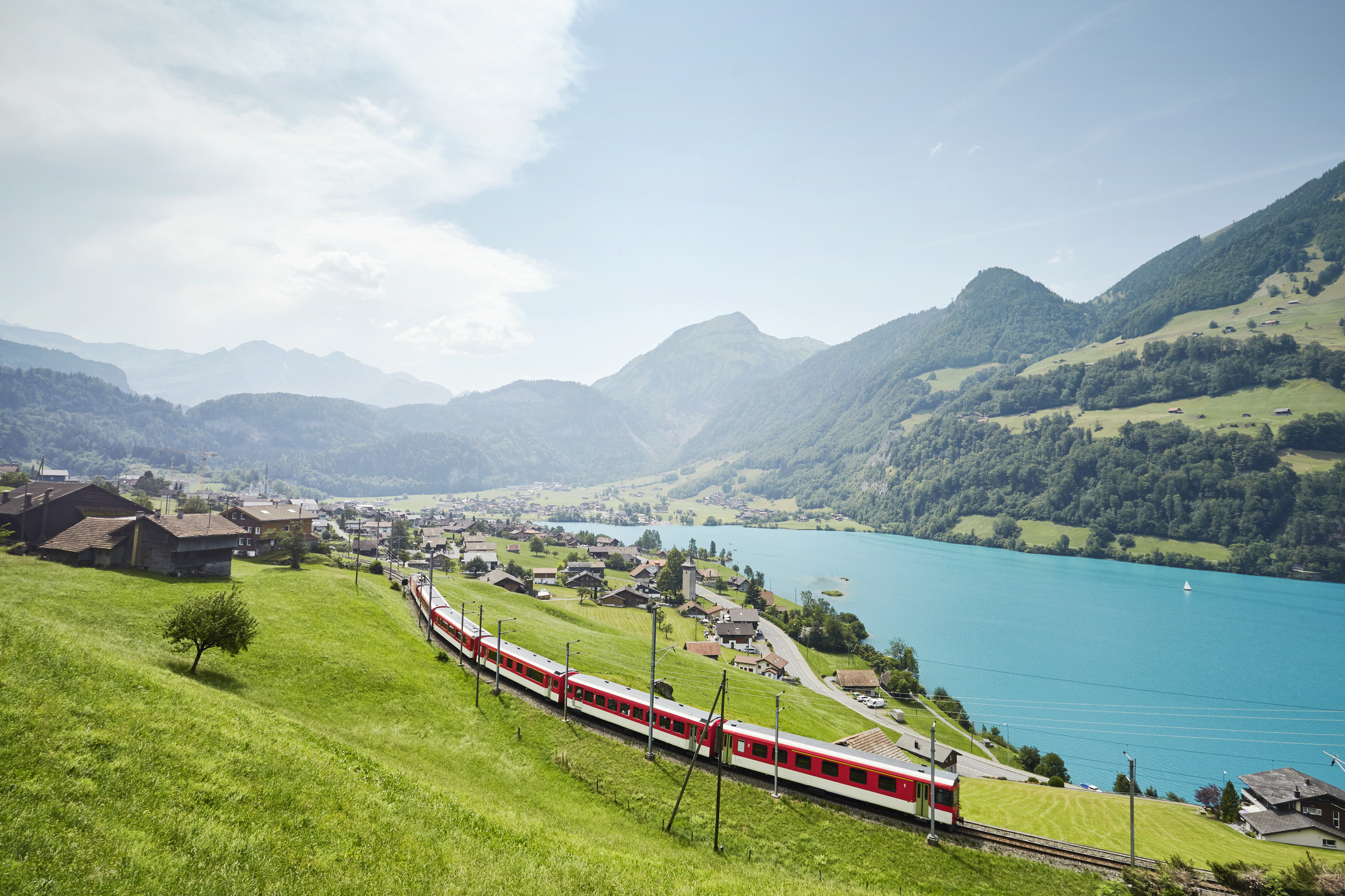 A train running through a countryside in Switzerland