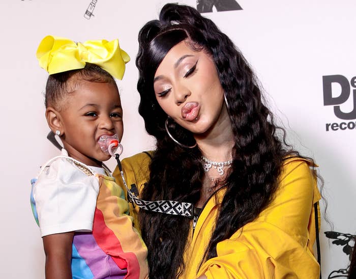 cardi holds kulture in her arms