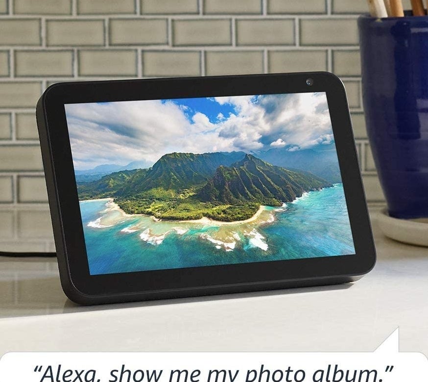 The Echo Show on a kitchen counter with a photo of a island on the display screen