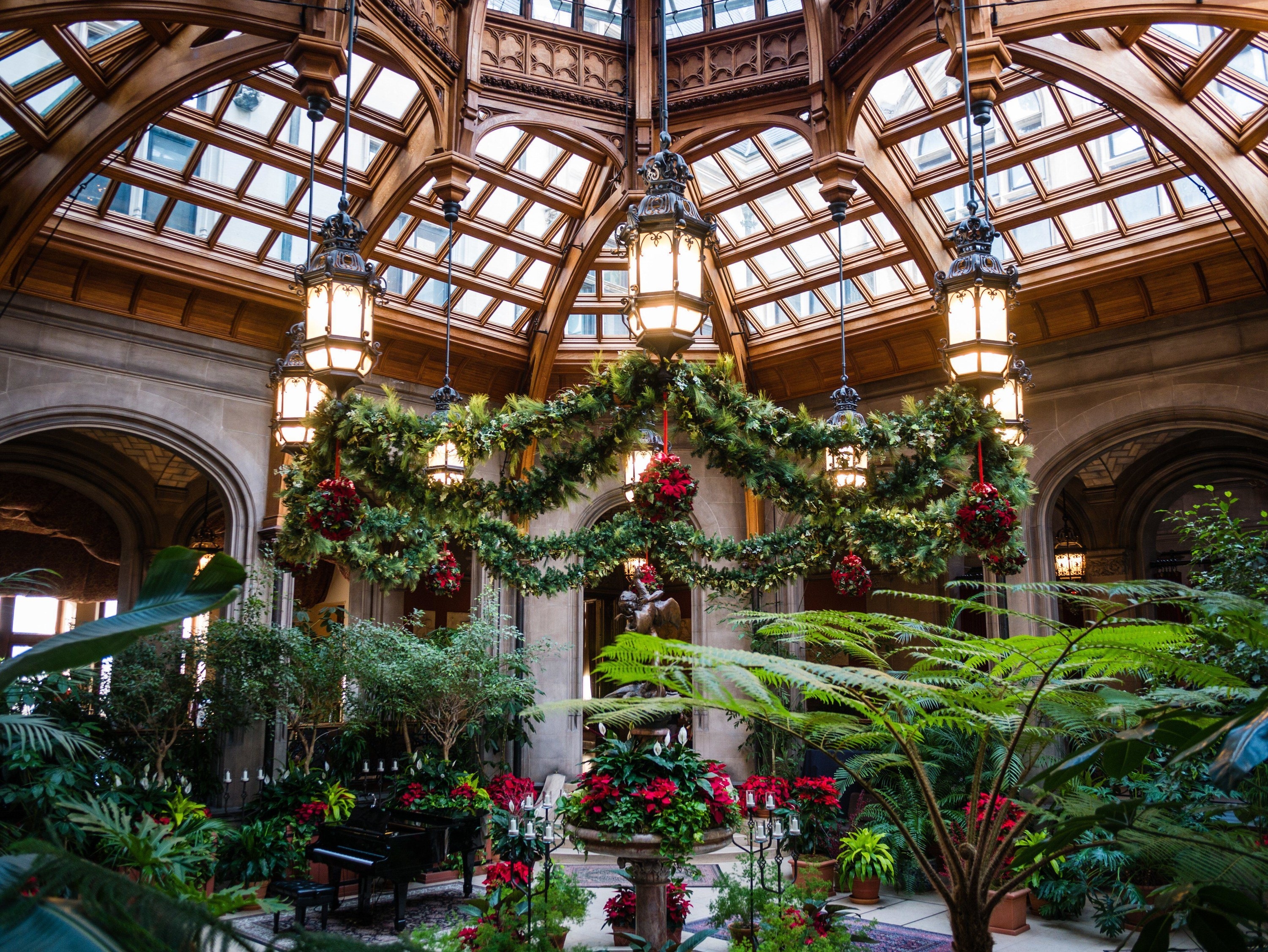 Inside the Biltmore decorated for Christmas with garland and poinsettas