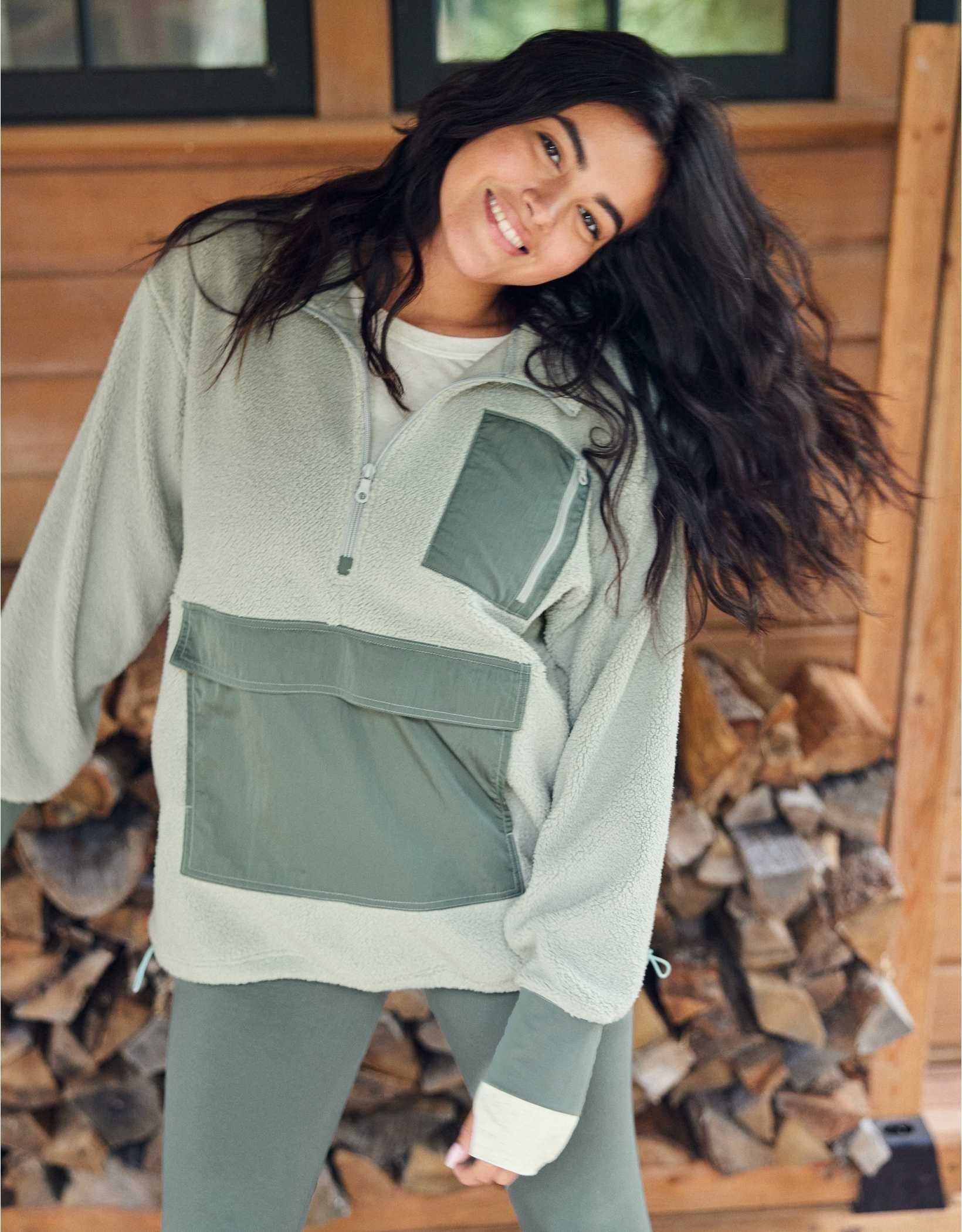 model wearing the green fuzzy jacket with dark green pockets