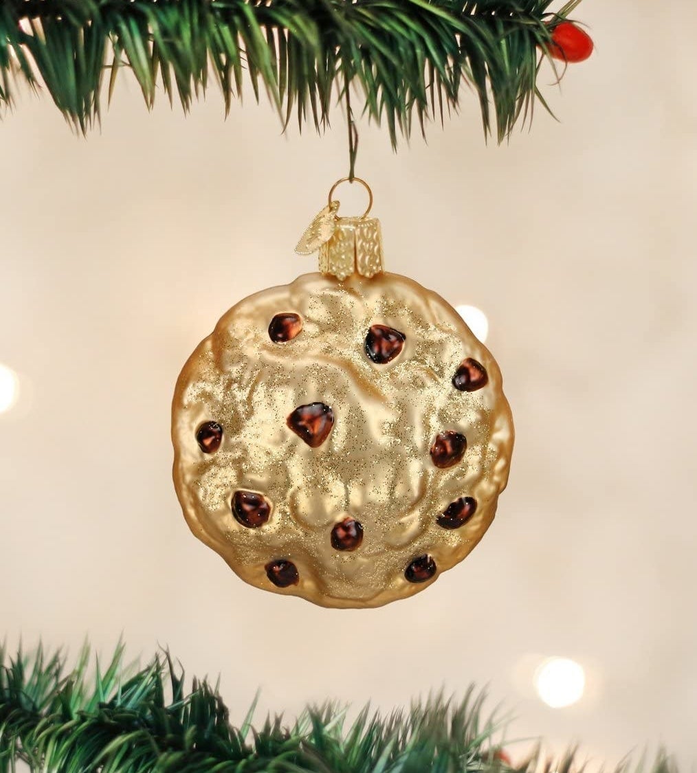 The chocolate chip cookie ornament hanging on a tree