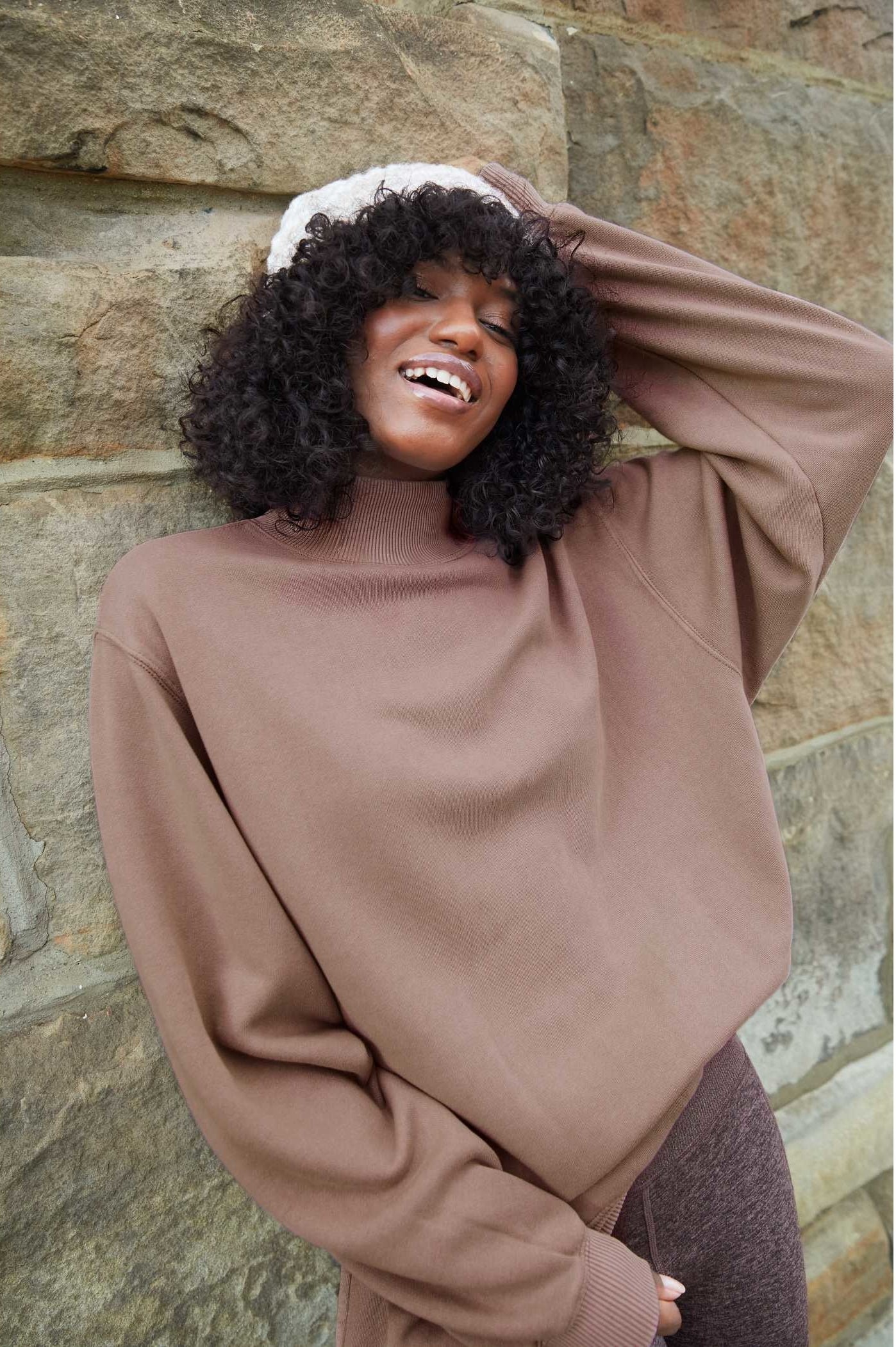 model wearing the mock neck sweatshirt in brown