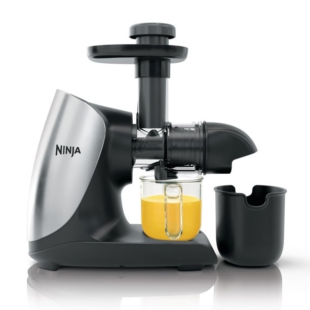 The Ninja juicer making orange juice.