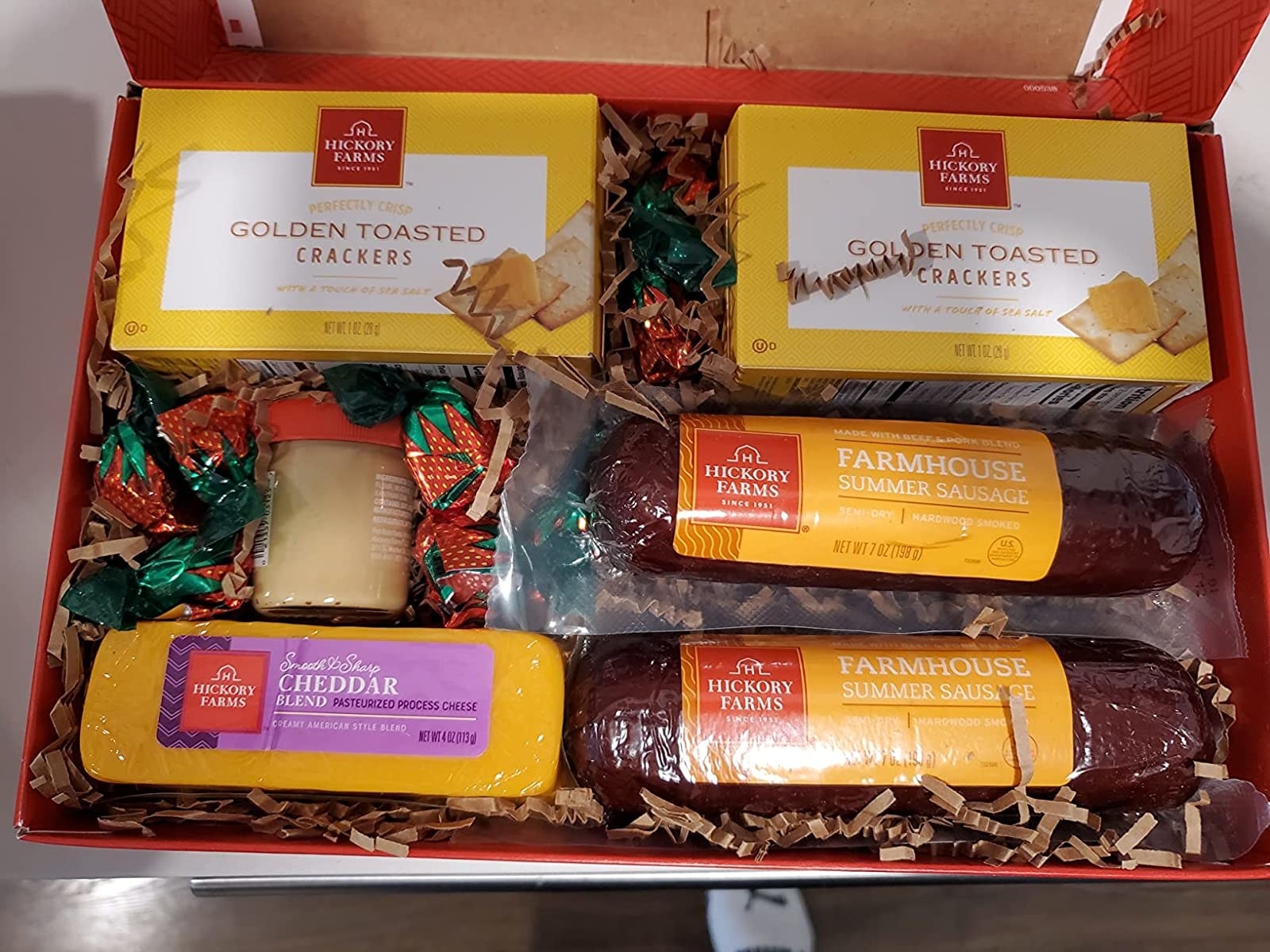 Reviewer photo of the gift box with crackers, two sausages, and cheese