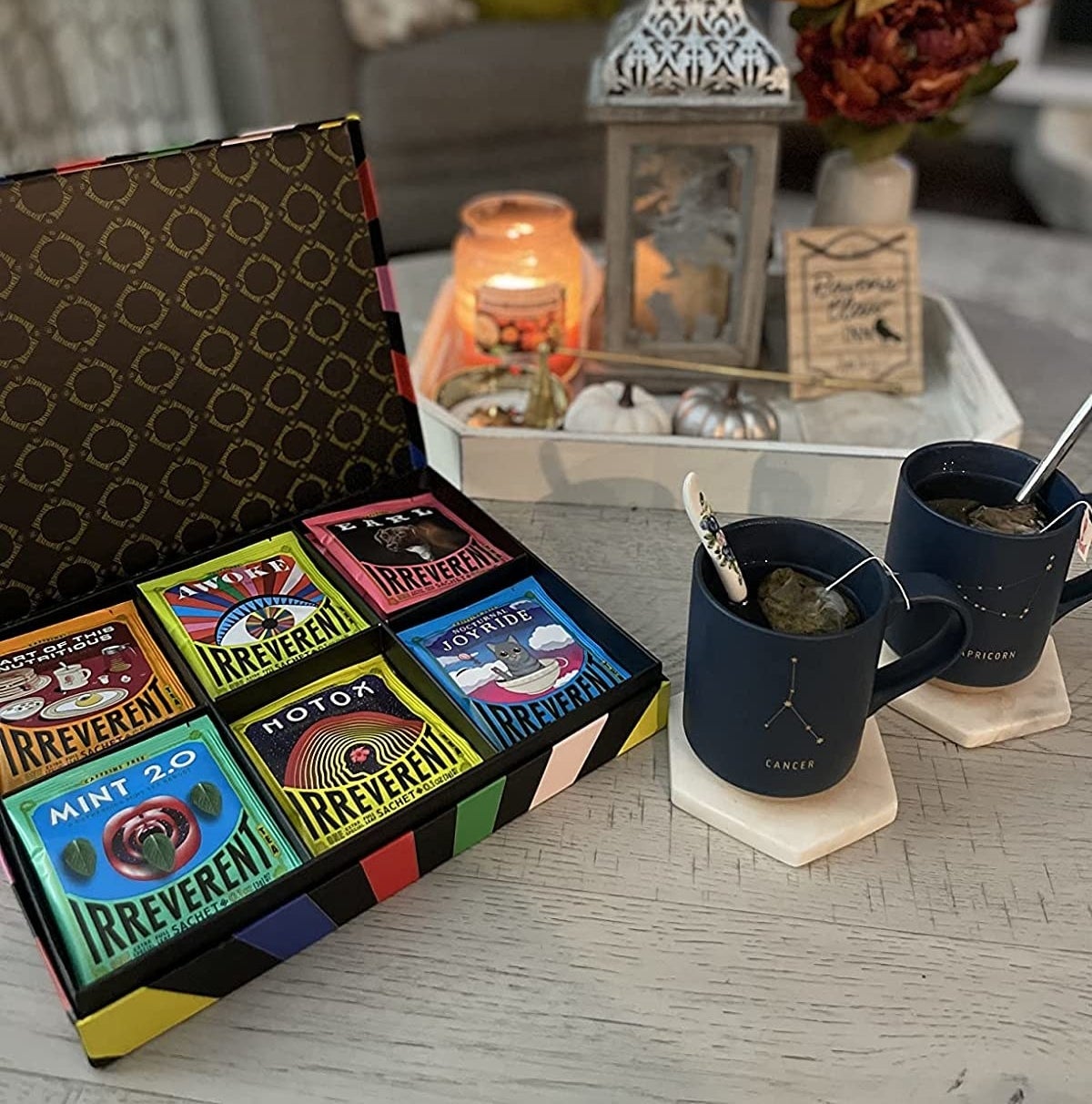 Reviewer photo of the tea sampler box next to two mugs of tea