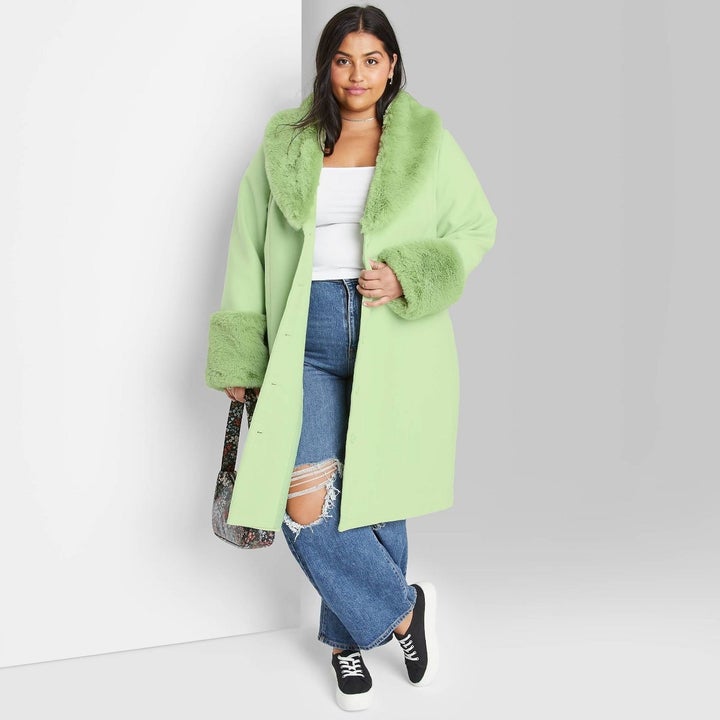 model wearing the green coat