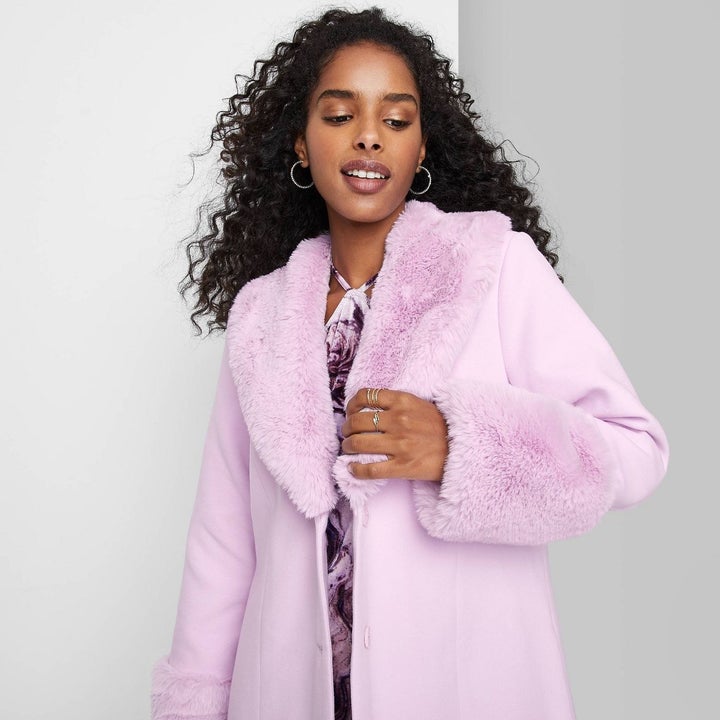 another model wearing the lavender coat
