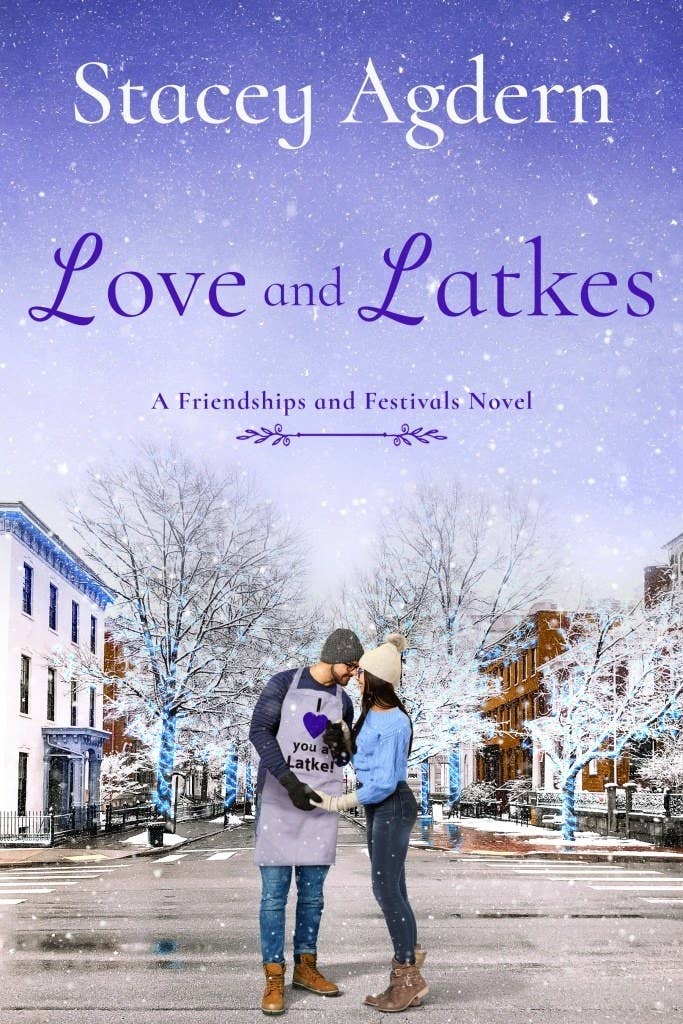 A white man, wearing an apron that says &#x27;I heart you a latke,&quot; and a white woman stand together on a snow covered street. The title reads: Love and Latkes. Below says, &quot;A Friendships and Festivals Novel.&quot;