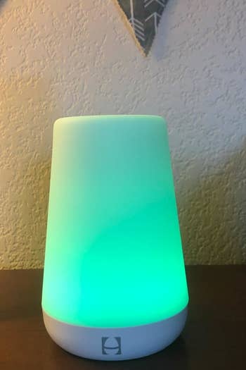 a reviewer photo of the sound machine illuminated green
