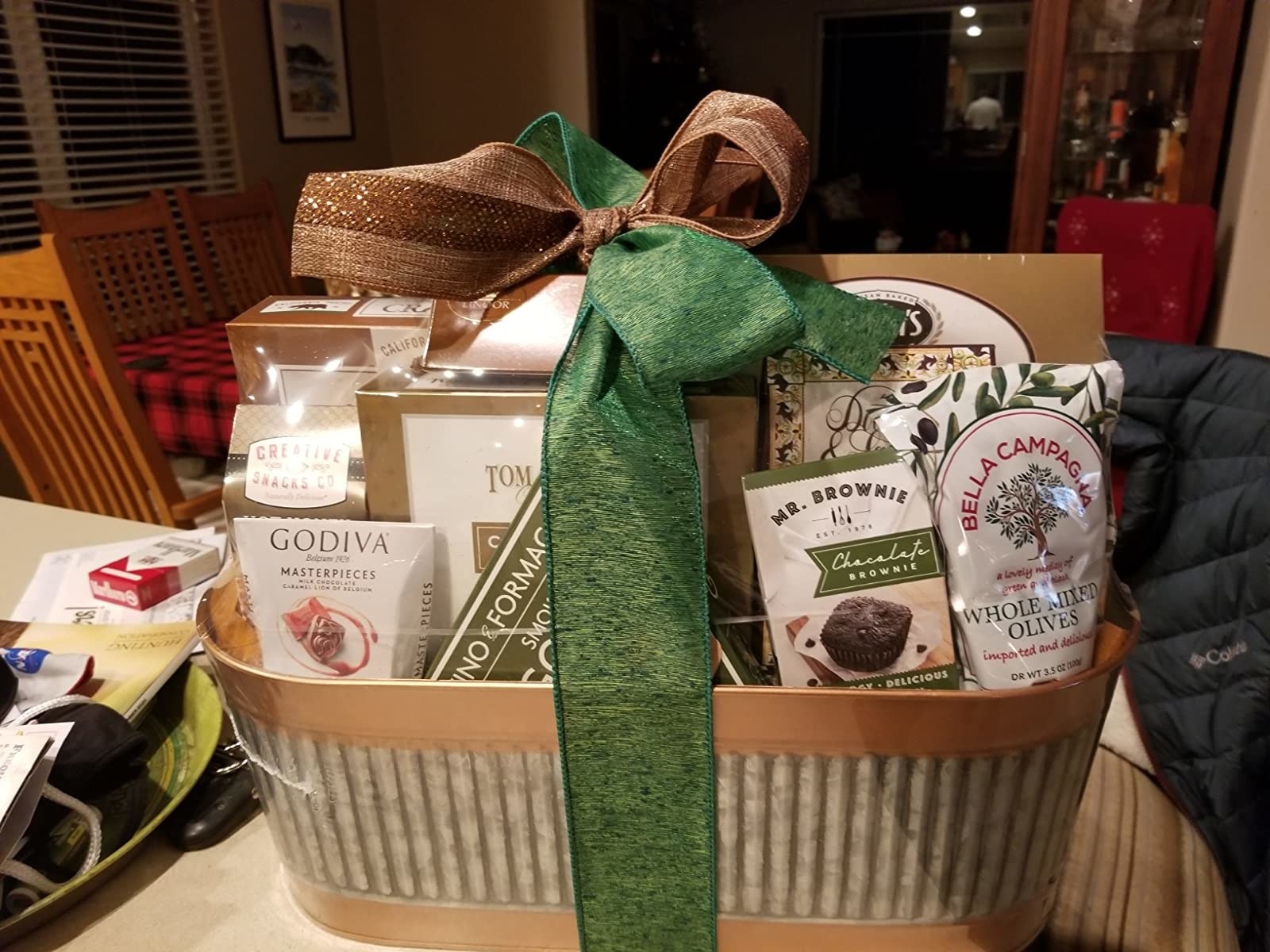 Reviewer photo of a basket with various treats such as olives, brownies, and chocolates