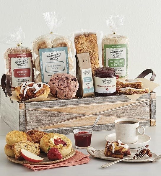 A box of various baked goods such as muffins, biscuits, and jam