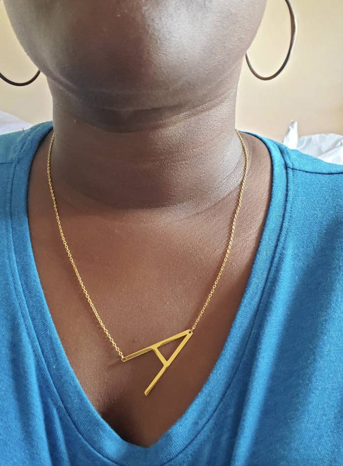 Reviewer wearing a gold monogrammed &quot;A&quot; necklace